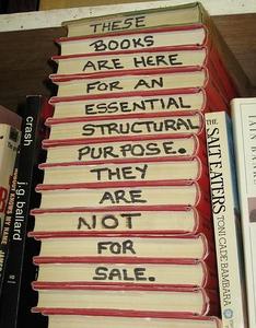 Depuis le temps que je dis que les livres ne servent qu'à tenir les étagères, voici une illustrations, avec, dans une librairie, des livres qui ne sont pas à vendre, mais qui sont présent dans un but structural. height=